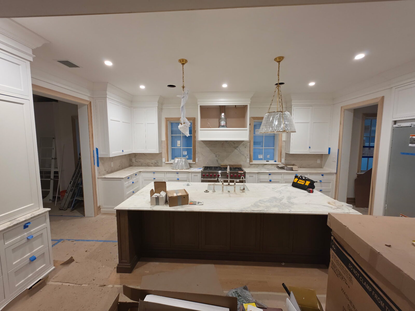 Kitchen remodel with a large island, custom cabinetry, and stone countertops.